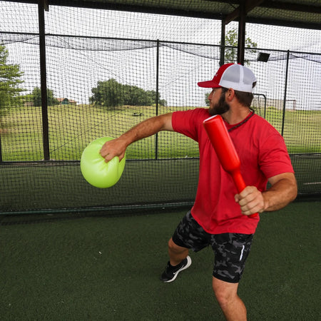 Action shot of the TAP® Connection Throwing Club, highlighting the distal-load stimulus for scapular stabilization and kinetic chain organization to build throwing arm power.