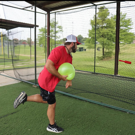 TAP® Connection Throwing Club shown at the moment of high-intent release, utilizing a distal-load stimulus for scapular stabilization and kinetic chain organization.