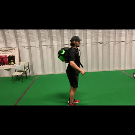 Athlete wearing the KHAOS® Cradle with the harness securely positioned between the scapulas, demonstrating the hands-free design for unrestricted movement during training.
