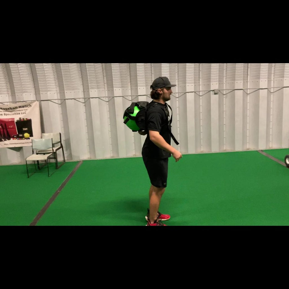 Athlete wearing the KHAOS® Cradle with the harness securely positioned between the scapulas, demonstrating the hands-free design for unrestricted movement during training.