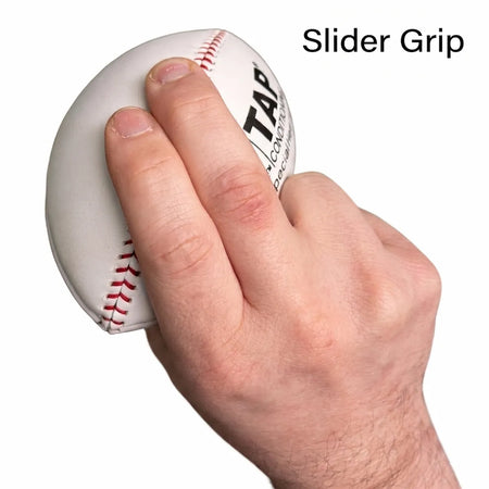 Hand holding the TAP® YAKKERAID in a two‑finger gyro slider grip on the laces to train tight spiral slider spin, release feel, and off‑speed pitch movement.