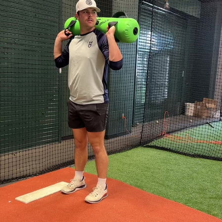 Auburn Tiger baseball pitcher utilizing the Khaos Waterboy during his pitching delivery. The dynamic water resistance uniquely activates core muscles, unlike static weights, for enhanced power and control.