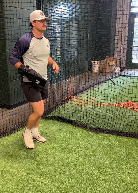 Athlete uses Baseball Training Sock for solo throwing drill to strengthen rear shoulder muscles.