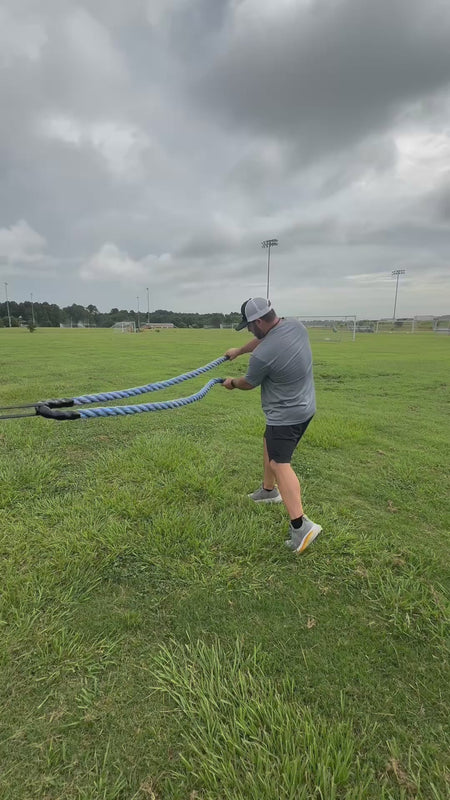 An athlete swinging the Dynamic Rope System to engage core muscles specifically for improved power transfer during a swing.