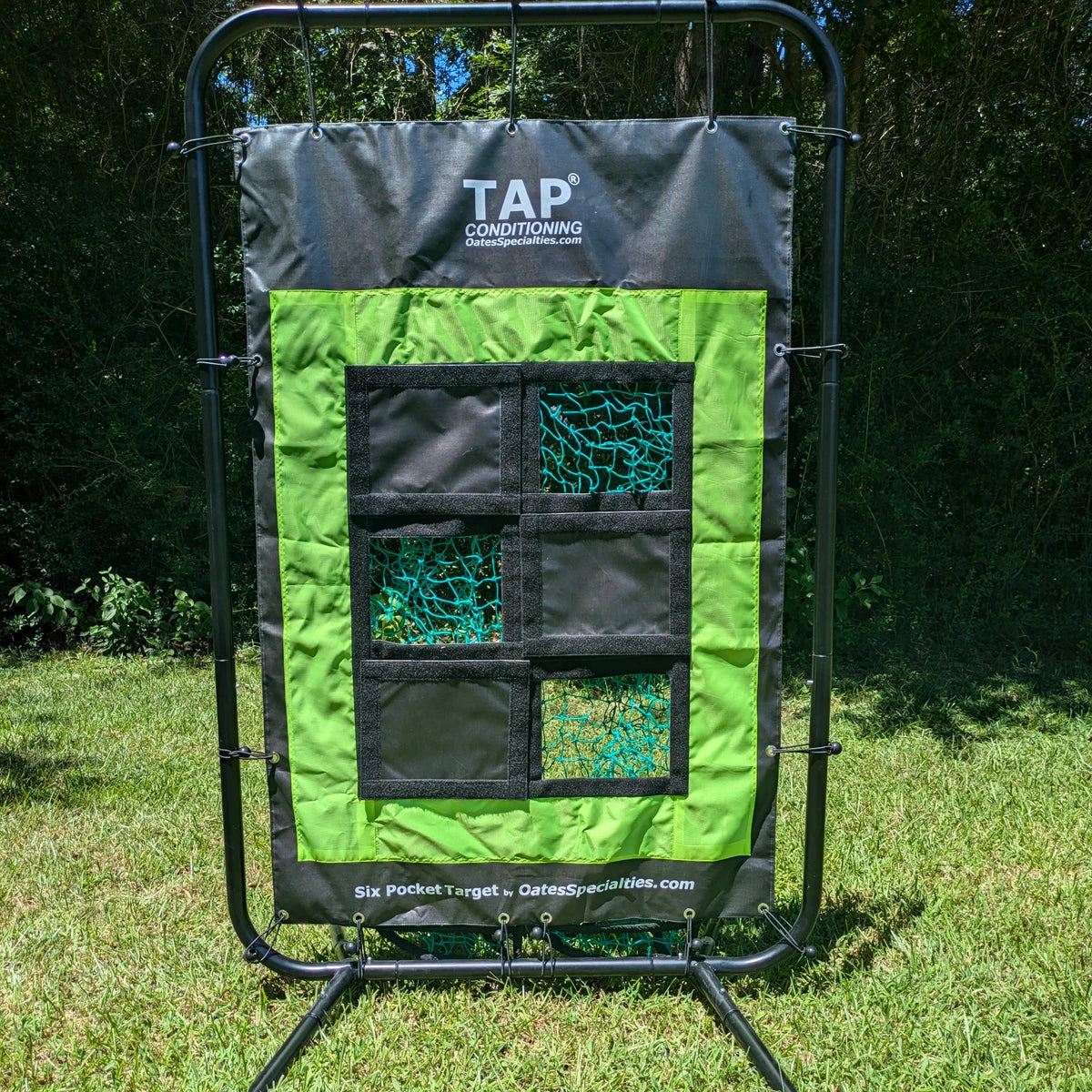 Front view of the TAP® Six Pocket Target station outdoors, with six pockets — three open net pockets and three covered pockets — on a green and black panel