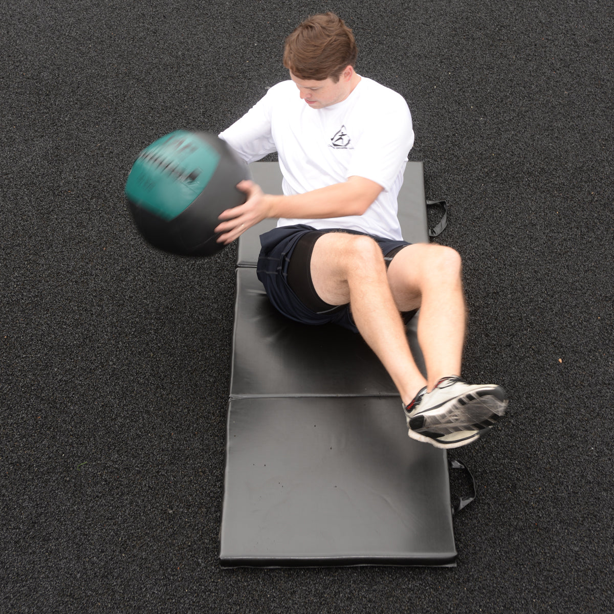 Soft Medicine Ball being used in a Russian twist for fast paced core training.