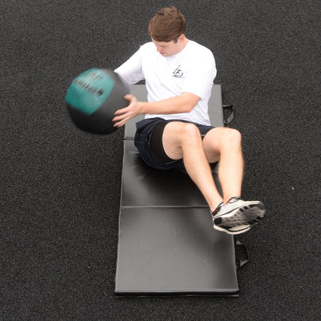 Soft Medicine Ball being used in a Russian twist for fast paced core training.