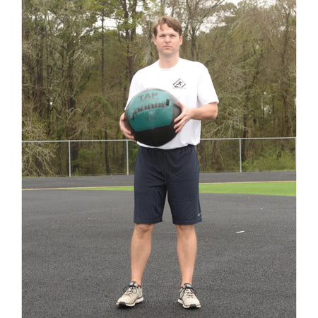 Soft Medicine Ball 16lb being held in both hands to demonstrate the size of the ball.