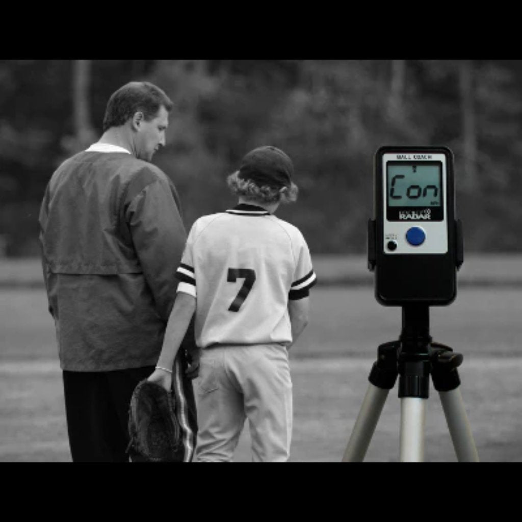 Here’s a clean, SEO-friendly alt text for that setup:
"Ball Coach™ radar gun positioned on a tripod for stable, hands-free pitch speed tracking during training or gameplay.