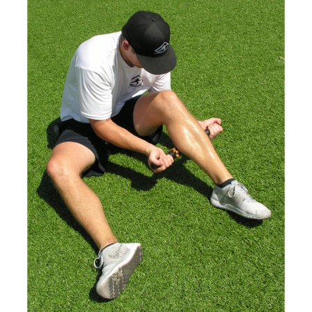 An athlete uses the relief stick for a myofascial release of the calf muscle. 