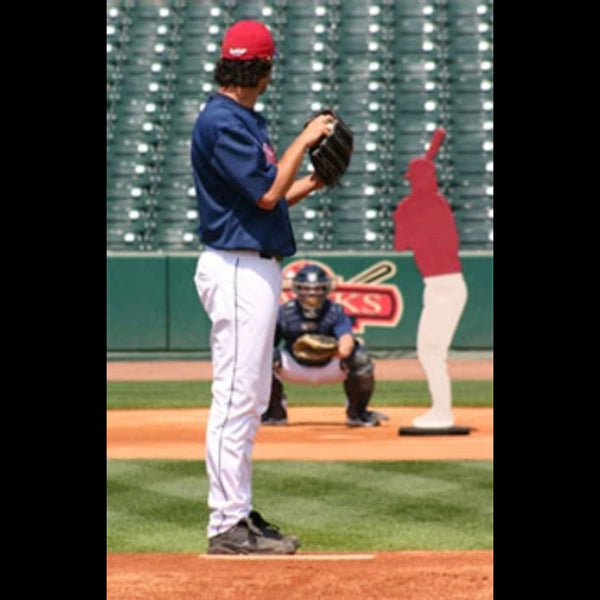 Baseball pitcher on the mound practicing with the Designated Hitter® dummy positioned in the batter’s box