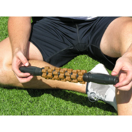 An athlete holding up a relief stick to display its size.