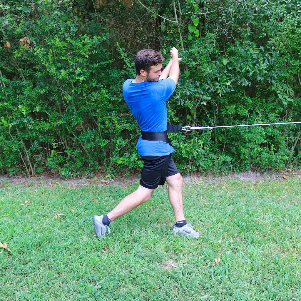 Donley Hip Spin attached to the athletes hip. It is resisting hip rotation while an athlete swings or pitches. 
