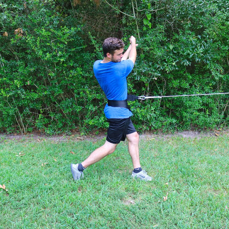 Donley Hip Spin attached to the athletes hip. It is resisting hip rotation while an athlete swings or pitches. 