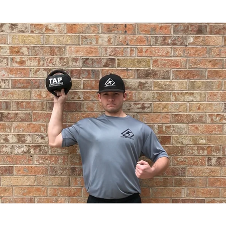 Athlete training with a Double Handle Medicine Ball—focusing on shoulder strength and enhancing internal rotation through controlled movement patterns.