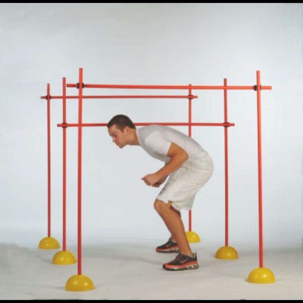 Indoor Agility Set Athlete Agility Training with the athlete standing up and ducking as he goes through the hurdles.