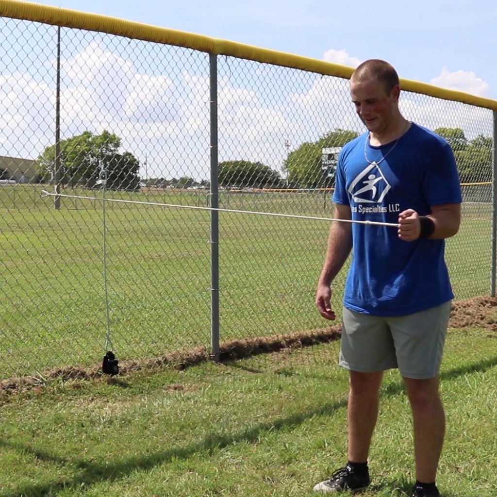 Athlete performing external shoulder rotation with resistance band, emphasizing rotator cuff activation and improved joint stability.
