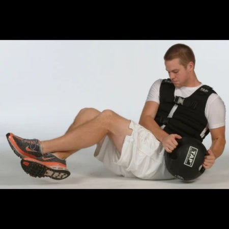 Athlete performing Russian twists with a Double Handle Medicine Ball—engaging core muscles through rotational movement for strength and stability training.