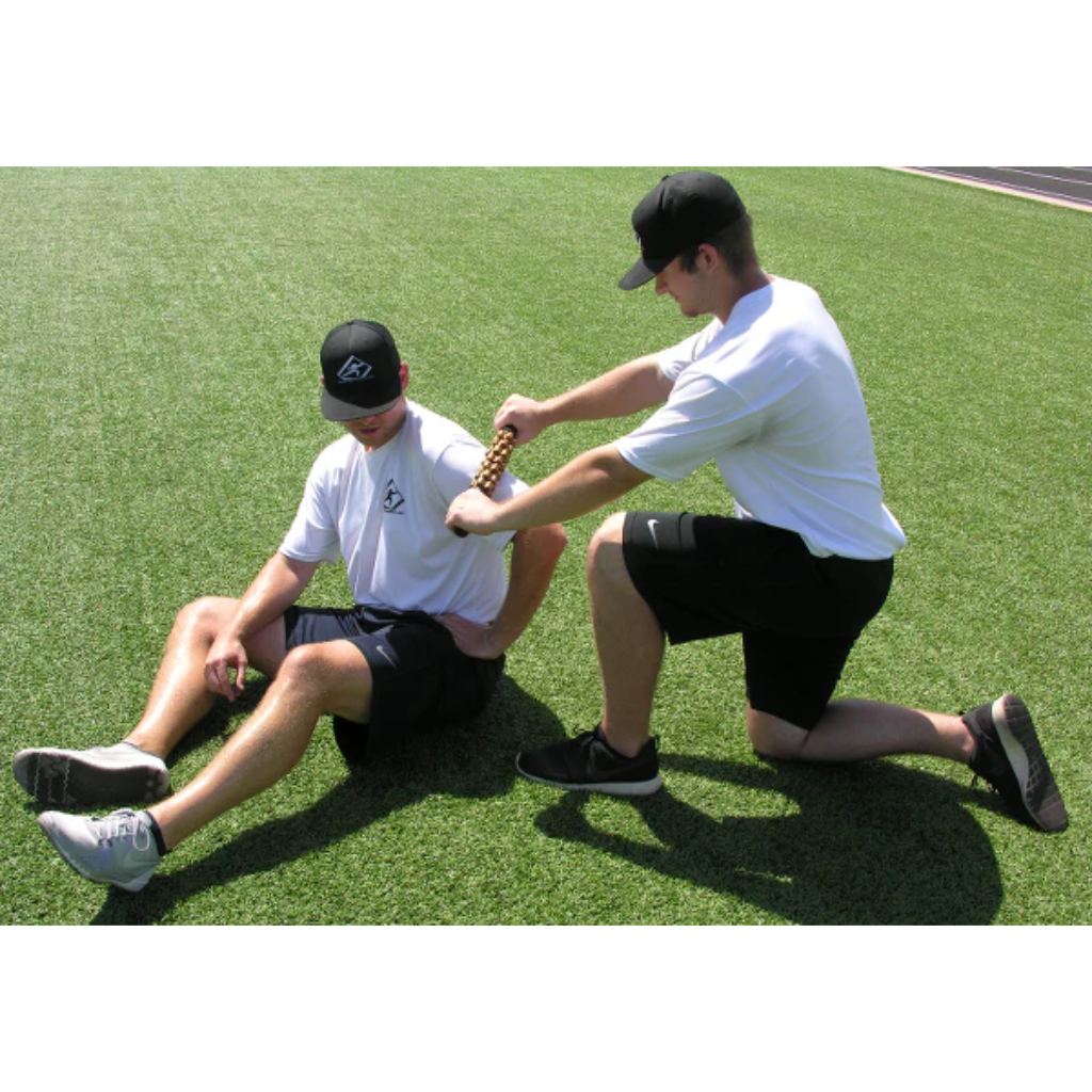 An athlete utilizes a partner to perform a deep tissue myofascial release of the shoulder.