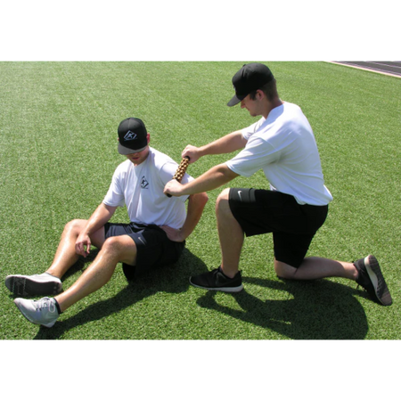 An athlete utilizes a partner to perform a deep tissue myofascial release of the shoulder.