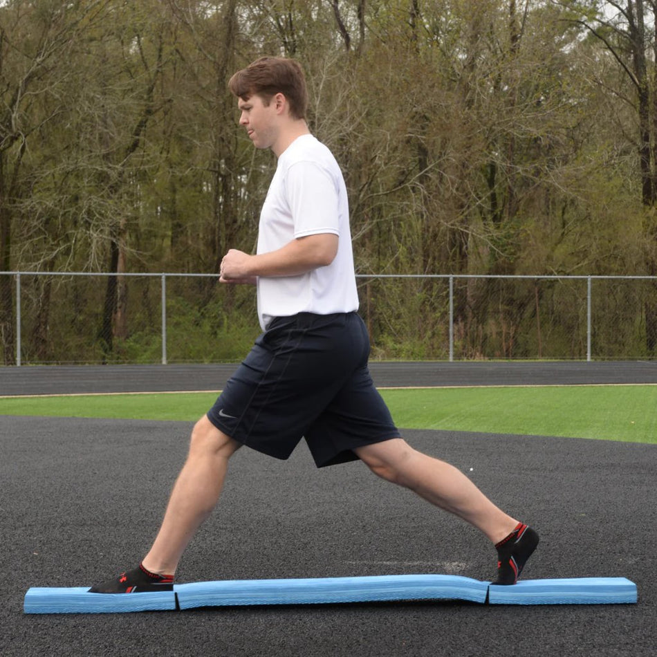 Athlete executing a standing split while balancing on the Folding Balance Beam, engaging core stability, flexibility, and control during dynamic training.
