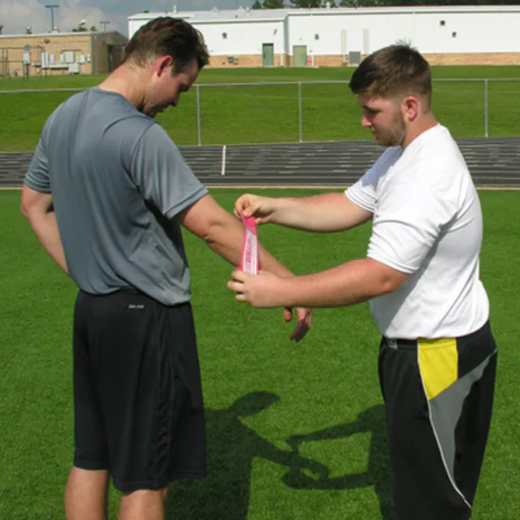 Rocket Wrap Compression Floss being wrapped around an arm, illustrating targeted compression to stimulate blood flow and support joint recovery.