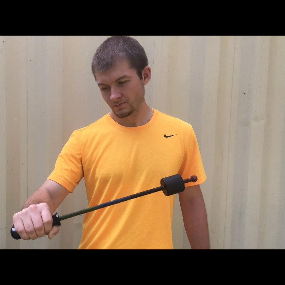 An athlete performs a wrist-strengthening exercise using the Supi Pro device, executing a controlled pronation movement to target forearm and wrist muscles.