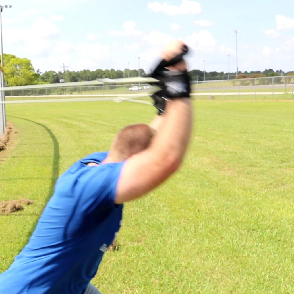 Athlete executing a full-body chop with Silver Ultimate Pitcher's Friend Tubing to enhance core power and strength.