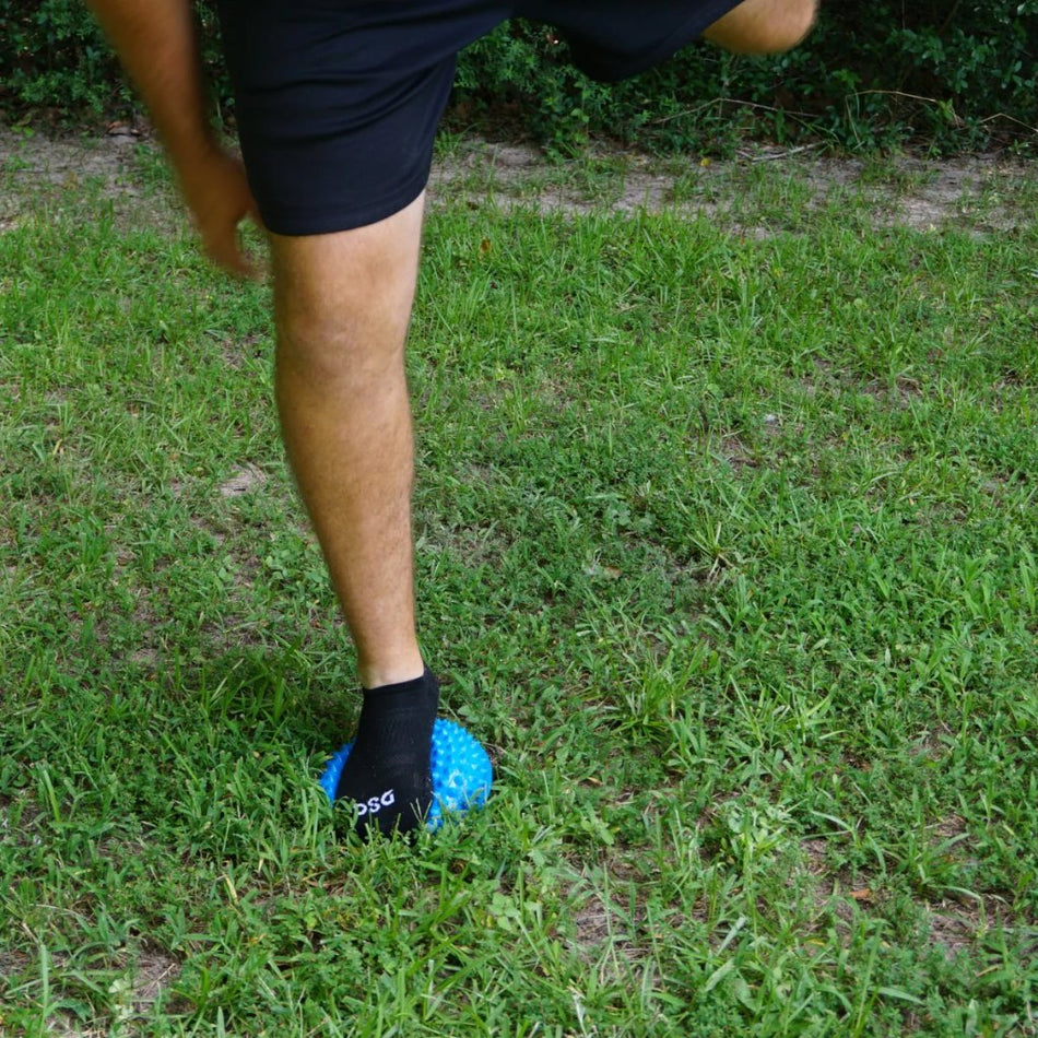 Balance Pod being stepped on with one foot as an athlete trains his lower extremities for strength, stability, and coordination.