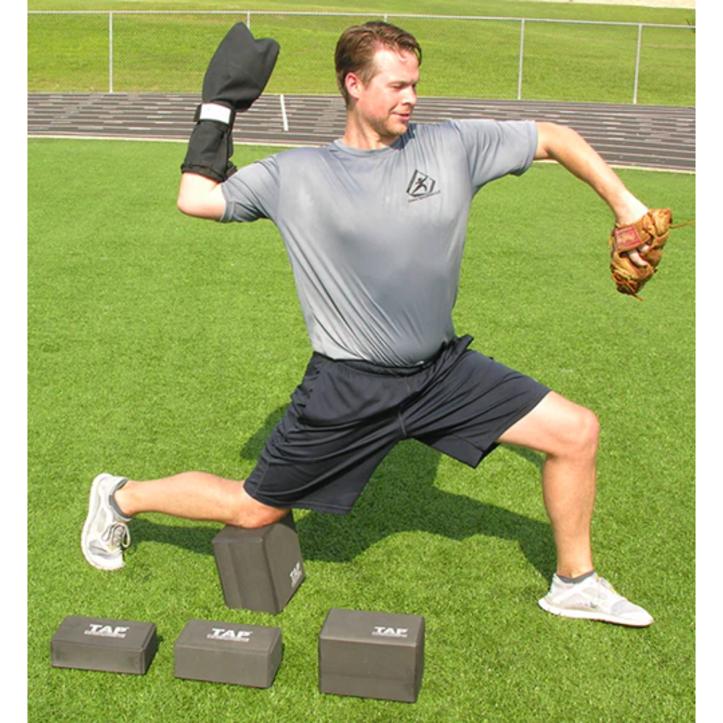 Baseball pitcher training with the TAP® Kneeling Block and a Training Sock in arm-cock throwing position.