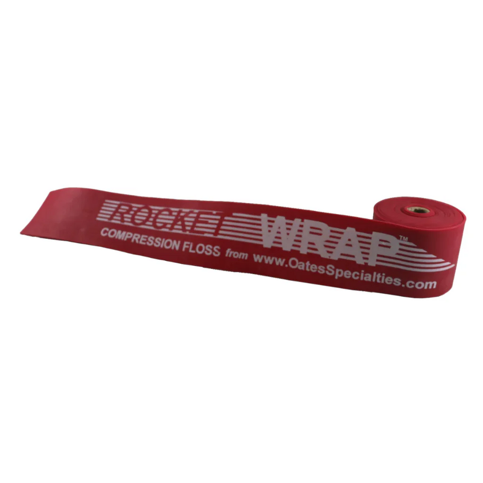 Red Rocket Wrap Compression Floss coiled neatly on a clean surface, showcasing its X-Heavy resistance level and durable natural latex construction.