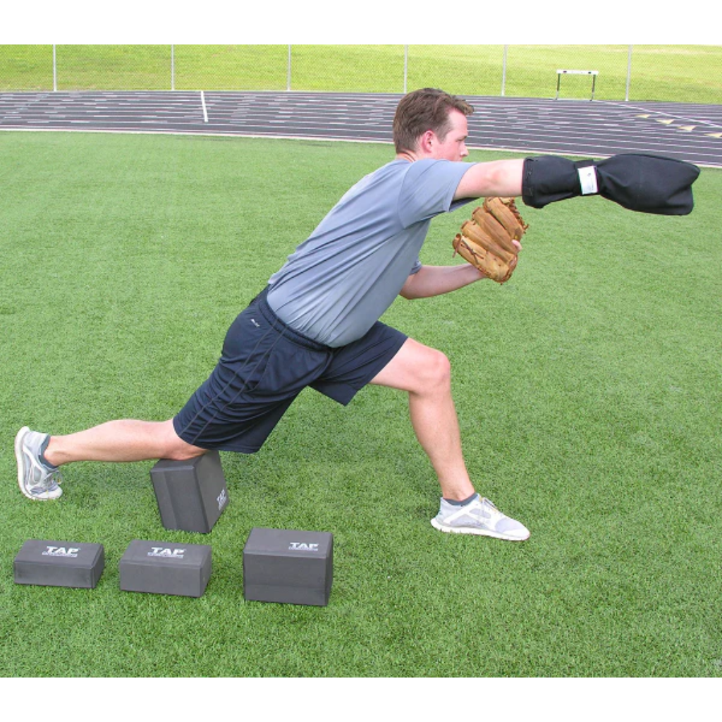 Baseball pitcher using the TAP® Kneeling Block and a Training Sock in the ball release position.